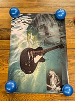 Full view of Kurt Cobain artistic poster featuring underwater effect with guitar and smaller inset photo.