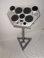 Front view of Yamaha DD-55 7-pad electronic drum module mounted on Quiklok stand with triangular base.