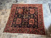 Full view of the Persian rug on tiled floor showing overall pattern and condition.