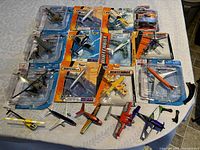 Full lot of 12 die-cast planes and helicopters from Matchbox and Maisto, both packaged and loose pieces