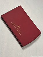 Closed burgundy case with gold embossed Royal Canadian Mint logo and bilingual text.