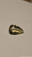 Pear-shaped lemon citrine gemstone displaying yellow lemon color and faceted cut.