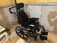 Side view of low rider wheelchair showing seat, backrest, footrests, and wheel size