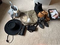 Wide photo showing the full lot including purse, hats, boots, shoes, and clothing item