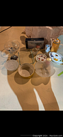 Image showing various bowls and dishes of glass and ceramic, also including small kitchen items and utensils.