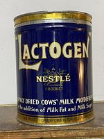 Front view of blue and gold vintage metal tin labeled ACTOGEN by Nestle, showing the product name and details clearly.