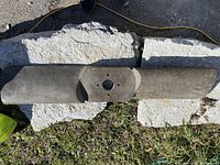 Top view of large aircraft propeller blade showing metal hub and blade surface