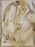 Full view of the faux pearl beaded decorative belt showing multiple strands of beads.