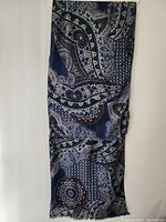 Full view of the scarf showing the overall navy blue with paisley and geometric pattern design.
