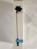 Photo of Paparazzi Selfie Stick box showing stick extended with phone mount and wired shutter button