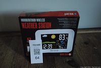 Front view of box showing wireless indoor/outdoor weather station with color LCD display and branded Smart Gear G.