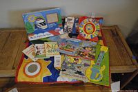 Full overview photo showing all items in the lot including books, toys, infant mat.