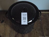 Top view of the large black enamel enameled pot with the lid on.