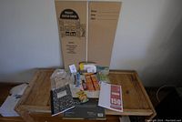 Photo showing full view of school supplies including project display board, glue sticks, notebooks, crayons, and other stationery items.