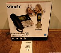 Photo of sealed boxed VTech Cordless and Corded Digital Answering System showing front of packaging with product images and features.