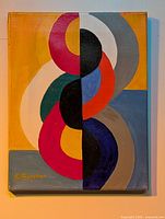 Front view of the original abstract painting showing vertical symmetry with colored oval shapes on yellow-gray background.
