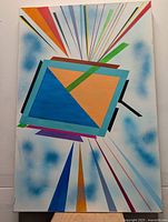 Photo shows an original abstract painting on canvas with geometric shapes and colorful rays, measuring approximately 24x36 inches.