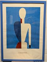 Framed K. Malevitsch print with abstract geometric figure on blue background. Shows colors and details of print and blue frame.