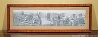 Front view of black-and-white panoramic photograph of downtown Chicago from 1909 in aged oak frame.