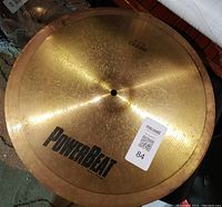 Top view of a PowerBeat 16 inch Crash Cymbal with visible wear and seller sticker.