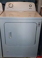 Front view of white Amana dryer showing door, control panel and push-to-start button