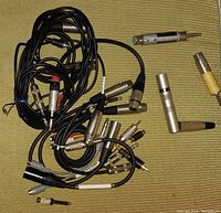 Top view showing multiple XLR connectors and cables with some adapters