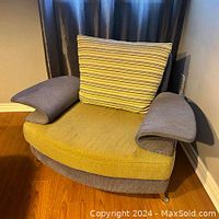 Front view of the 1960's style side chair showing fabric upholstery in mustard yellow and blue-grey with striped cushion and padded arms.