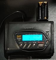 Sony TCD-D8 DAT Walkman powered on showing 'NO TAPE' on LCD screen, with battery holder attached on top.