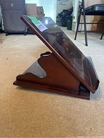 Side view of the collapsible wood book stand showing its angled position and support structure