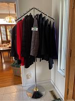 Multiple women's jackets on display rack including a variety of brands and styles