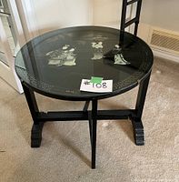 Front view of round folding accent table with inlaid tabletop