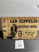 Front view of the new Led Zeppelin advertisement tin sign with vintage concert ticket design showing date May 17, 1975 and Earls Court Arena venue.