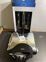 Napoleon 3-piece stainless steel BBQ tool set in original packaging accompanied by a Philips electric toaster in silver and black.