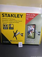 Full box packaging of Stanley Full Motion TV Wall Mount TLX-350FM with branding and product image showing mount and TV display.