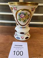 Front view of the vintage painted amber crystal vase showing floral motif and gold trim with cutout design at the base and body