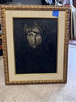 Framed portrait painting of a woman, showing the entire framed piece with ornate gold frame and linen mat border.