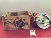 Black & Decker circular saw with original cardboard box showing model 7390 and blade size.