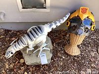 WowWee Classic Roboraptor mechanical dinosaur toy displayed on a rock outdoors