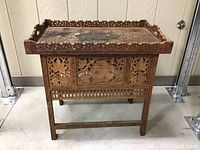 Full view of the Indian wood carved side table showing detailed carving and tray top.