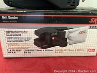 Box of Skil belt sander showing specifications and model number (7313)