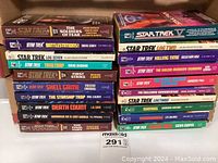 Stack of 20 Star Trek paperback novels showing titles and authors on spines.