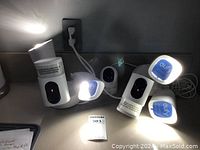 Overview of Eufy cameras, including 2 Pan & Tilt cameras with protective skins, multiple CAM 2 cameras, and 2 motion sensors together on a tabletop.