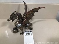 Front side of the bronze finished steampunk dragon holding the orb showing overall design and condition.