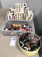 Full lot overview of multiple bins and containers holding a wide variety of vintage buttons, including buttons still on original cards from various brands.