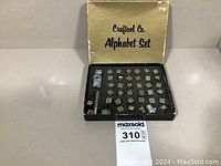 Photo showing vintage Craftool Co. alphabet stamp tools arranged in labeled box