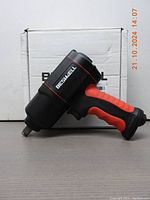 Side view of BESWELL air impact wrench showing red and black color with ergonomic handle and gun-style shape.