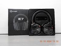 COWIN E7 headphones in original black box packaging with headphones set inside plastic tray.