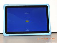 Front view of 10.1-inch kids tablet with blue protective case, showing screen with 'Hi there' startup screen.