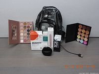 Full view of all makeup and skincare items laid out with carrying case and USB cable