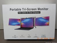 Front of box showing promotional image of portable tri-screen monitor and tagline one cable for dual displays